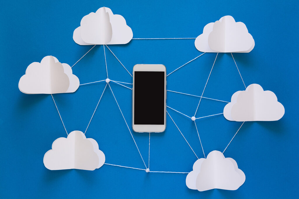 Network connection and cloud storage technology concept. Data communications and cloud computing network concept. Smart phone flying on origami paper clouds
